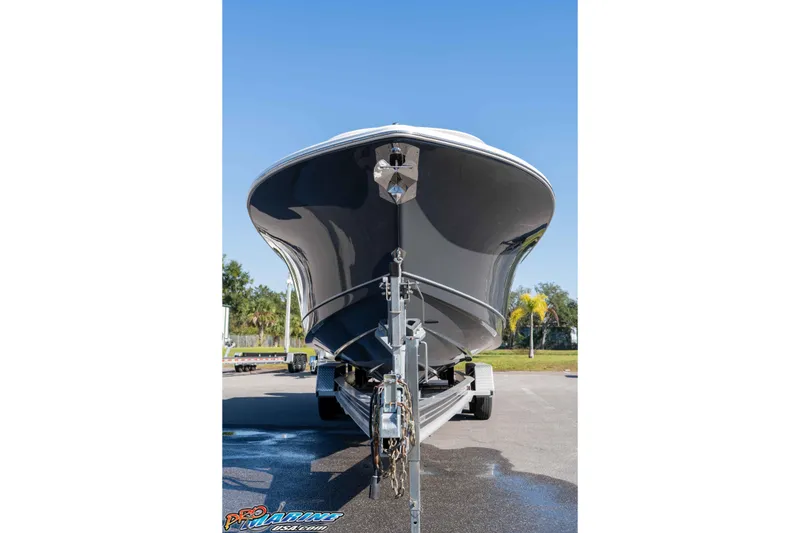 Slide: The Image of 2026 Sea Hunt Gamefish 28 Coffin Box boat on trailer, front view under clear sky. - 17