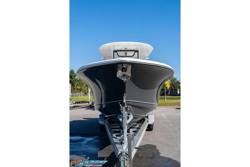 Slide: The Image of 2026 Sea Hunt Gamefish 28 Coffin Box boat on trailer, front view, clear sky. - 19