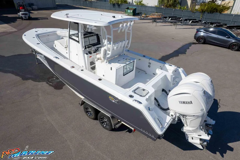 Slide: The Image of 2026 Sea Hunt Gamefish 28 Coffin Box boat with dual Yamaha engines on a trailer. - 20