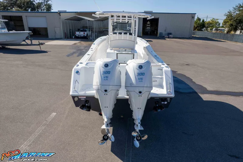 Slide: The Image of 2026 Sea Hunt Gamefish 28 Coffin Box with dual 300 V6 engines, parked outdoors. - 24