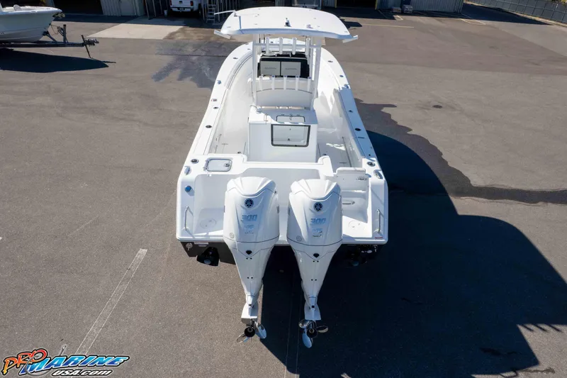 Slide: The Image of 2026 Sea Hunt Gamefish 28 Coffin Box boat with dual engines, parked on asphalt. - 26