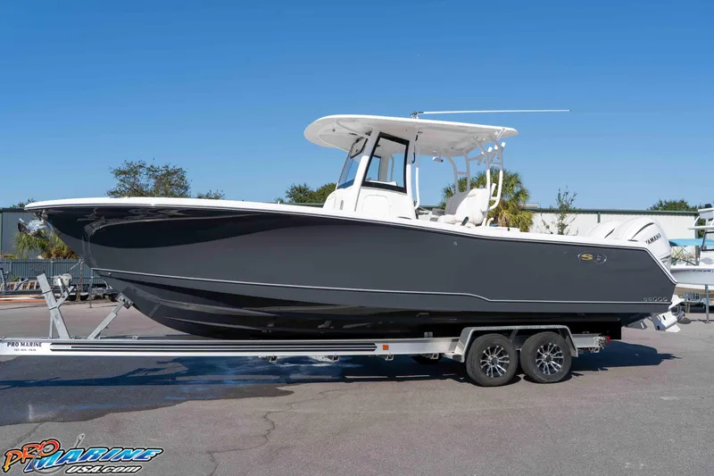 Slide: The Image of 2026 Sea Hunt Gamefish 28 Coffin Box boat on trailer, side view, outdoors. - 27