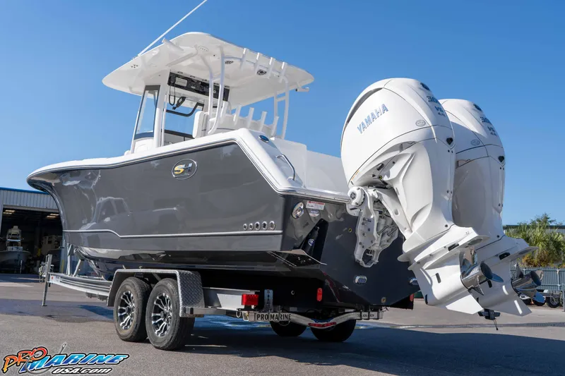 Slide: The Image of 2026 Sea Hunt Gamefish 28 Coffin Box boat with dual Yamaha engines on trailer. - 29