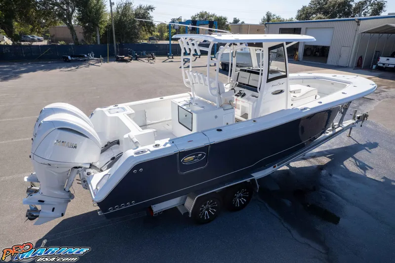 Slide: The Image of 2026 Sea Hunt Gamefish 28 Coffin Box boat with Yamaha engines, parked outdoors. - 30
