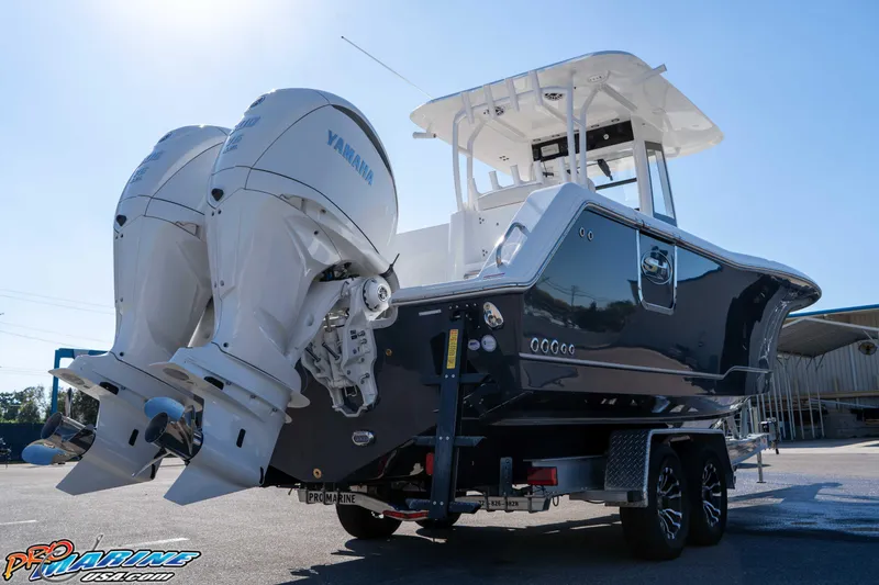 Slide: The Image of 2026 Sea Hunt Gamefish 28 Coffin Box boat with dual Yamaha engines on trailer. - 35