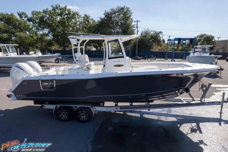 Slide: The Image of 2026 Sea Hunt Gamefish 28 Coffin Box boat on trailer, outdoor display. - 36