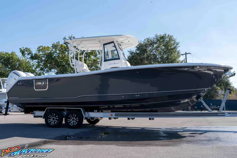 Slide: The Image of 2026 Sea Hunt Gamefish 28 Coffin Box boat on trailer, side view, outdoors. - 37