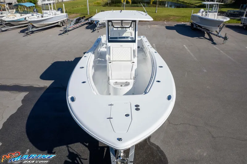 Slide: The Image of 2026 Sea Hunt Gamefish 28 Coffin Box boat displayed in a parking lot. - 6