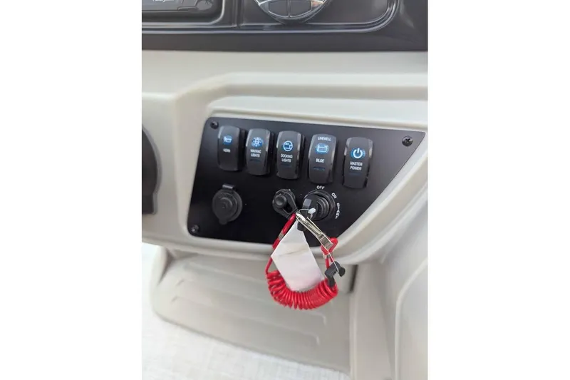 Slide: The Image of Control panel of 2026 Dockside 22DQ boat with switches and safety lanyard. - 13
