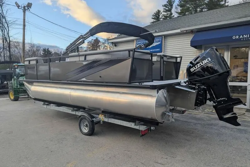 Slide: The Image of 2026 Dockside 22DQ pontoon boat with Suzuki outboard motor on trailer. - 3