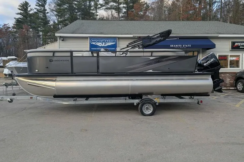 Slide: The Image of 2026 Dockside 22DQ pontoon boat on trailer, parked outside dealership. - 4