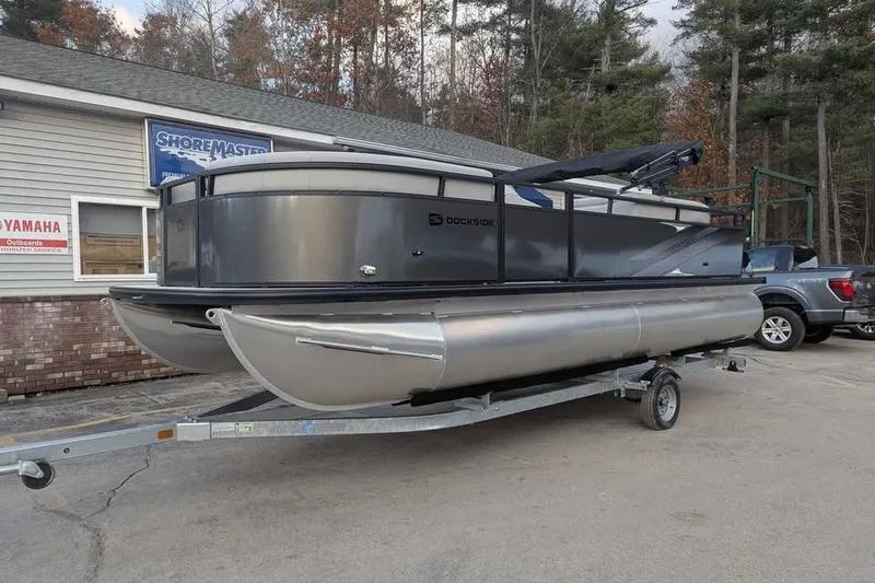 Slide: The Image of 2026 Dockside 22DQ pontoon boat on trailer, parked outside dealership. - 5