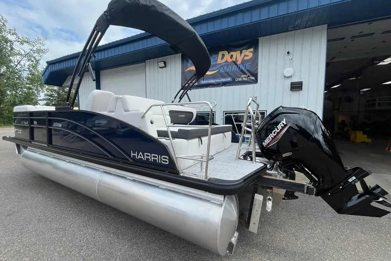 Slide: The Image of 2026 Harris Cruiser 210 pontoon boat with Mercury engine at marina. - 1