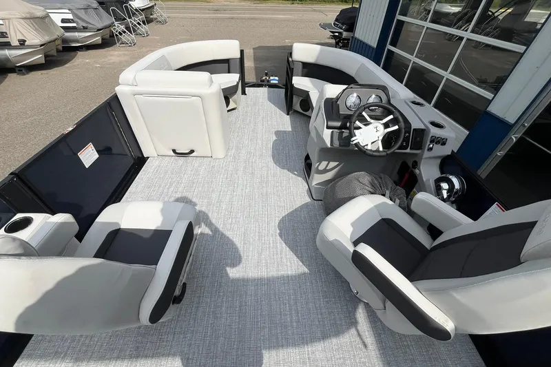 Slide: The Image of 2026 Harris Cruiser 210 boat interior with modern seating and steering console. - 17