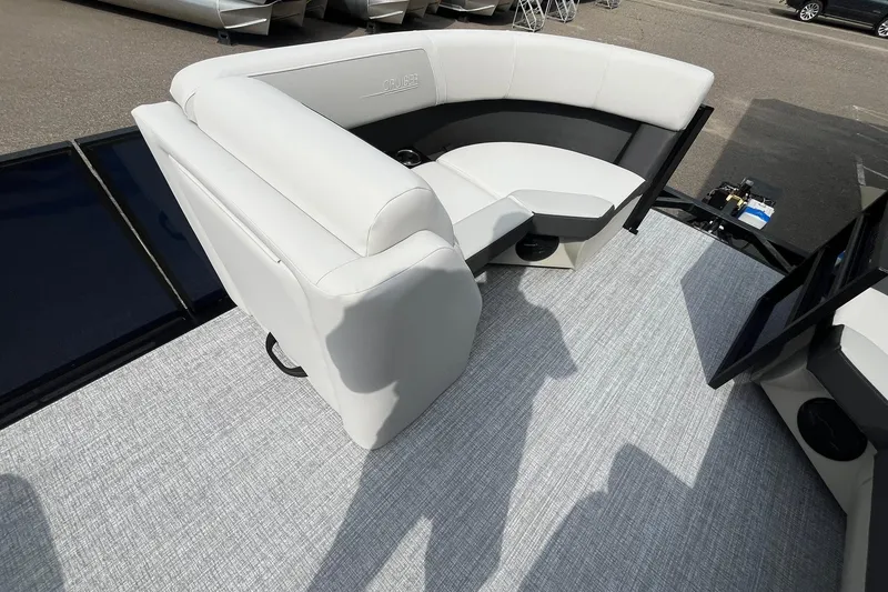 Slide: The Image of 2026 Harris Cruiser 210 boat interior with white and black seating on a textured floor. - 19