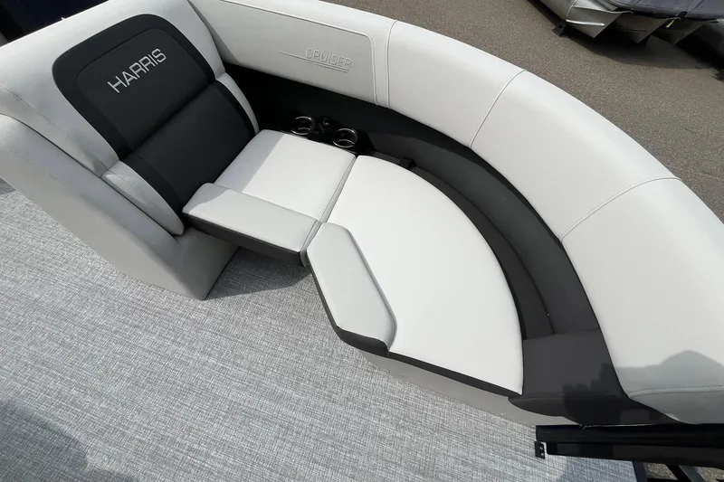 Slide: The Image of 2026 Harris Cruiser 210 boat interior with plush seating and cup holders. - 9