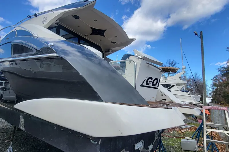 Slide: The Image of 2008 Marquis 40 SC yacht on dry dock under a blue sky. - 10