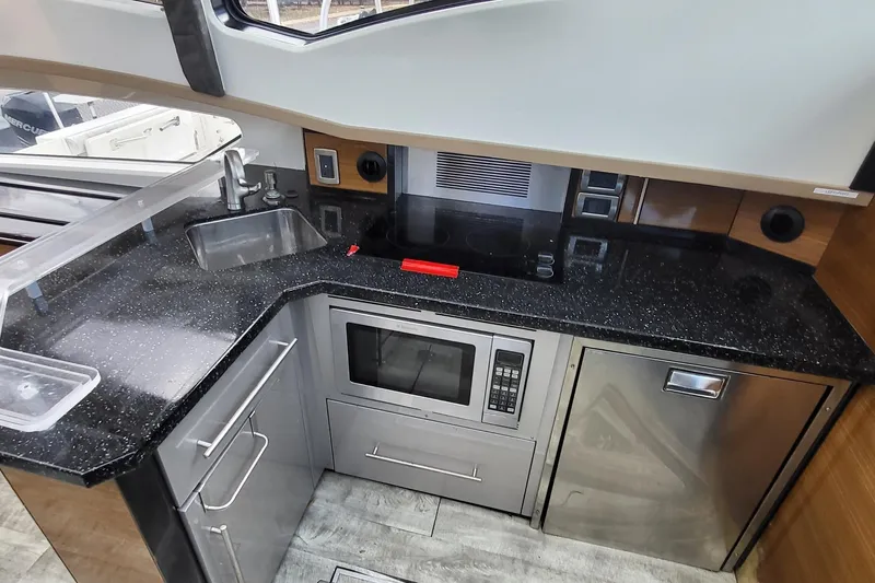 Slide: The Image of Modern kitchen in 2008 Marquis 40 SC yacht with sleek appliances and black countertops. - 14