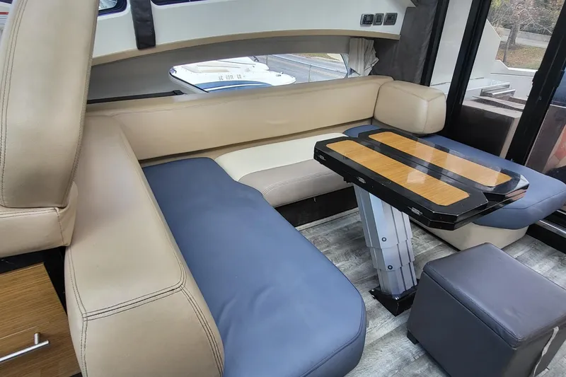 Slide: The Image of Luxurious interior of a 2008 Marquis 40 SC yacht with modern seating and table. - 15