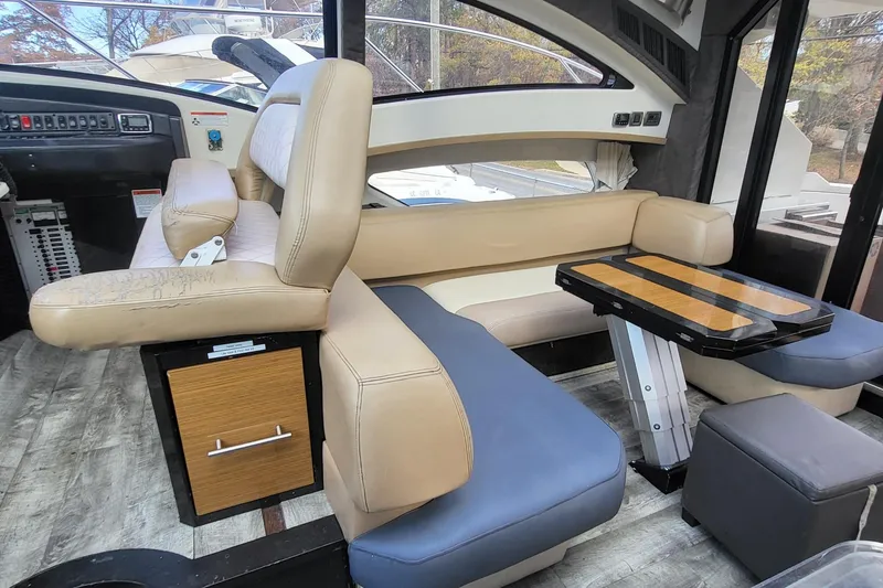 Slide: The Image of Interior of a 2008 Marquis 40 SC yacht with beige seating and a wooden table. - 16