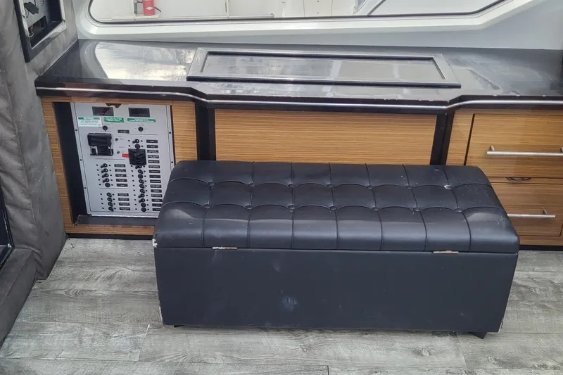 Slide: The Image of 2008 Marquis 40 SC yacht interior with control panel and black cushioned bench. - 18