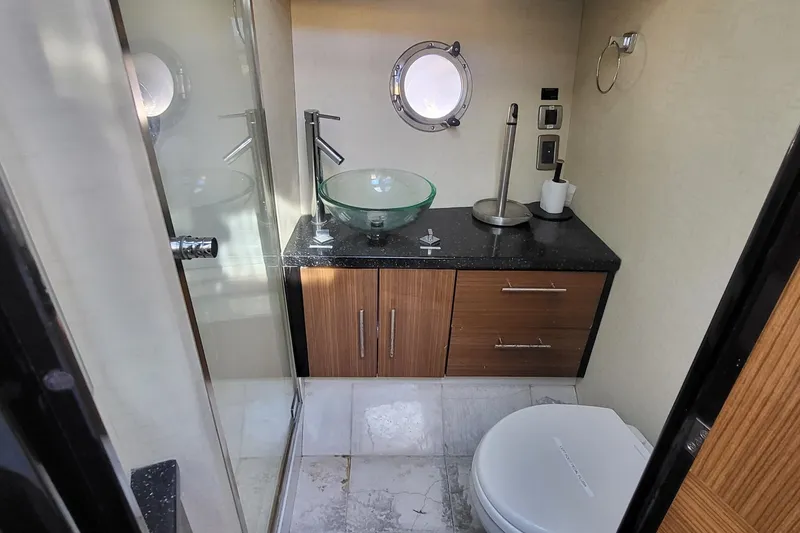 Slide: The Image of Luxurious bathroom in 2008 Marquis 40 SC yacht with modern fixtures and porthole window. - 19