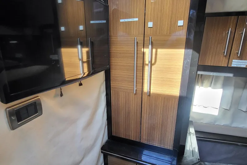 Slide: The Image of Interior of 2008 Marquis 40 SC yacht with sleek wooden cabinetry and modern design. - 21