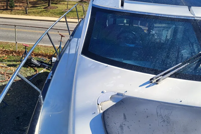 Slide: The Image of 2008 Marquis 40 SC yacht deck with windshield and railing, parked near a road. - 3