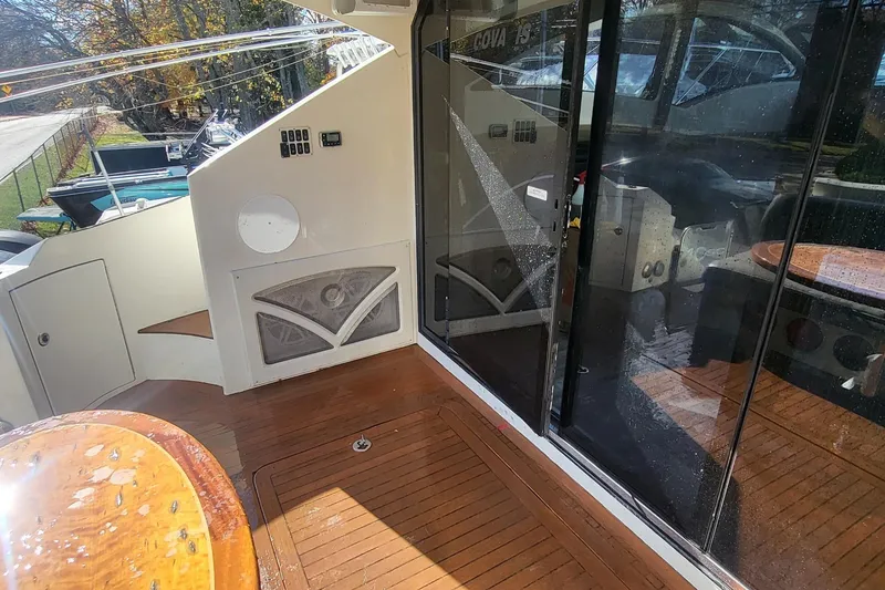 Slide: The Image of 2008 Marquis 40 SC yacht deck with wooden flooring and glass doors. - 6