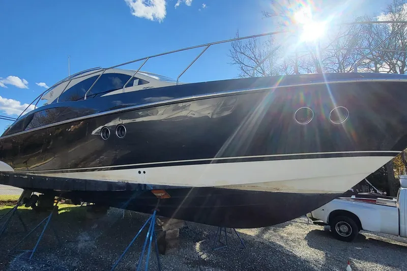 Slide: The Image of 2008 Marquis 40 SC yacht on stands, sunlit, with a clear blue sky background. - 8