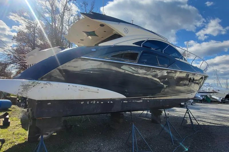 Slide: The Image of 2008 Marquis 40 SC yacht on stands under a partly cloudy sky. - 9