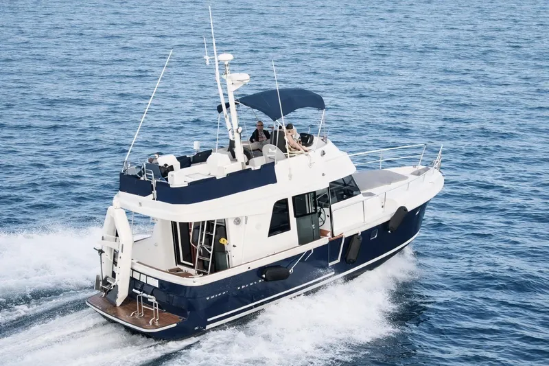 Slide: The Image of 2017 Beneteau Swift Trawler 34 cruising on open water, showcasing sleek design and performance. - 1