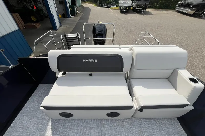 Slide: The Image of 2026 Harris Cruiser 210 boat with white seating and sleek design. - 12