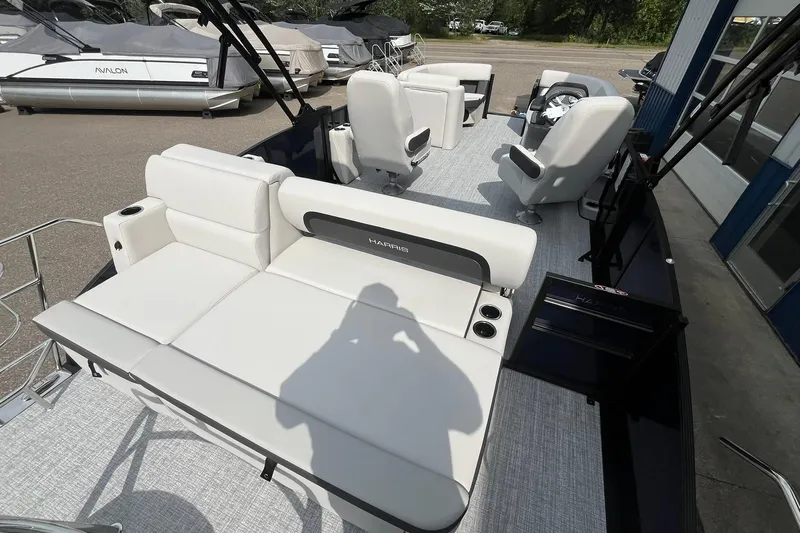 Slide: The Image of 2026 Harris Cruiser 210 pontoon boat interior with white seating and modern design. - 16