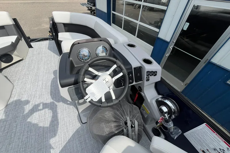 Slide: The Image of 2026 Harris Cruiser 210 boat dashboard with steering wheel and control panel. - 19