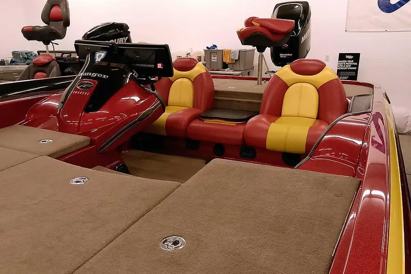 Slide: The Image of 2008 Ranger Z520 Comanche boat interior with red and yellow seats, carpeted deck. - 10