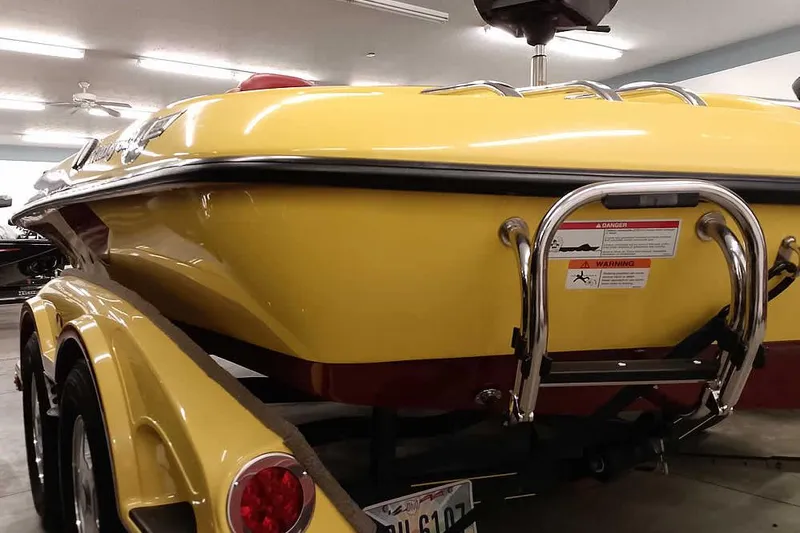 Slide: The Image of Yellow 2008 Ranger Z520 Comanche boat on trailer in indoor storage. - 12