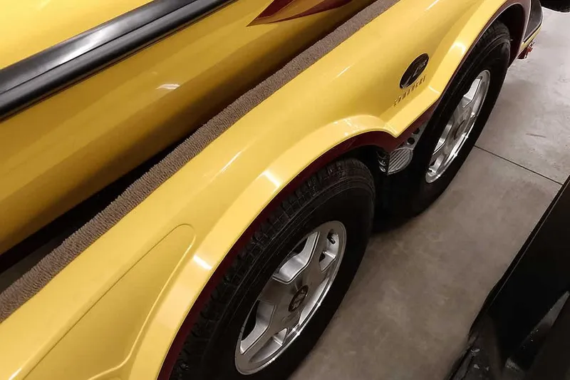 Slide: The Image of Yellow 2008 Ranger Z520 Comanche boat trailer with dual wheels in a garage. - 16