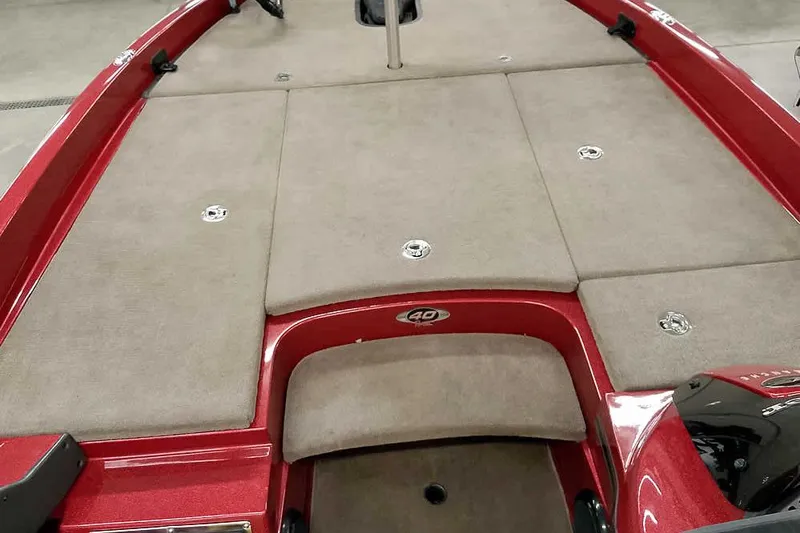 Slide: The Image of 2008 Ranger Z520 Comanche boat deck with red trim and beige carpet. - 19