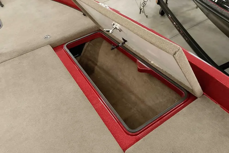 Slide: The Image of Open storage compartment on 2008 Ranger Z520 Comanche boat, featuring red and beige interior. - 24