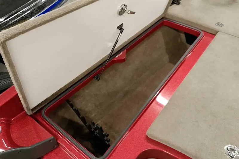 Slide: The Image of Open storage compartment in 2008 Ranger Z520 Comanche boat, featuring red and beige interior. - 25