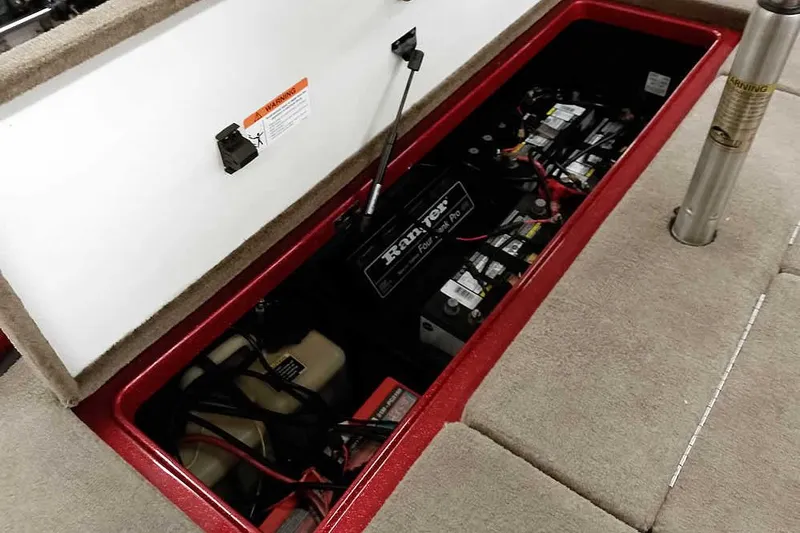 Slide: The Image of 2008 Ranger Z520 Comanche boat battery compartment with multiple batteries and wiring. - 43