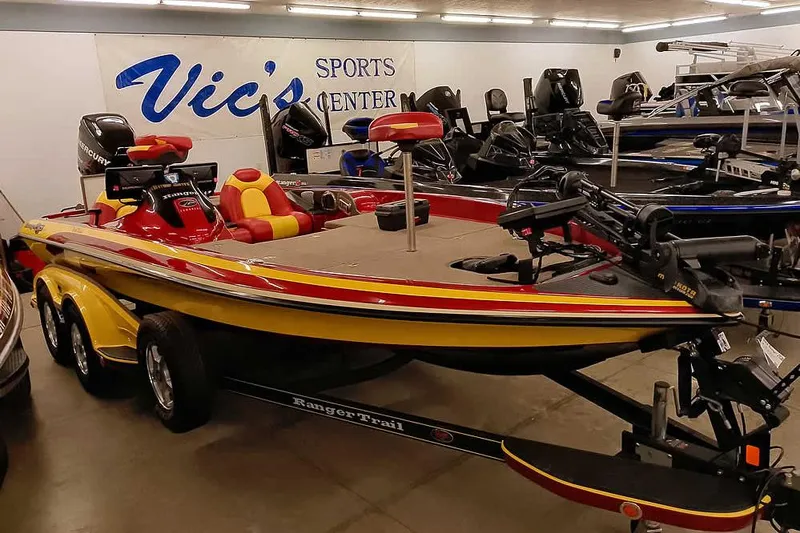 Slide: The Image of 2008 Ranger Z520 Comanche boat in showroom, yellow and red design, Vic's Sports Center. - 47