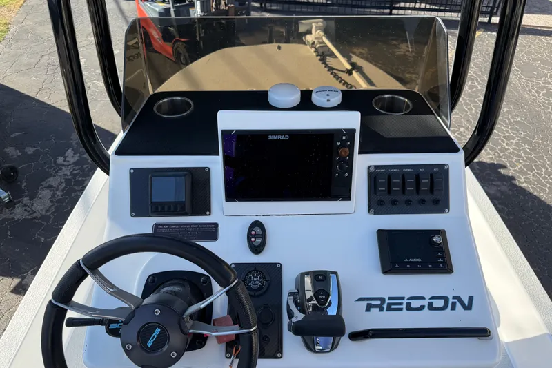 Slide: The Image of 2018 SCB Recon boat dashboard with steering wheel, controls, and navigation system. - 10