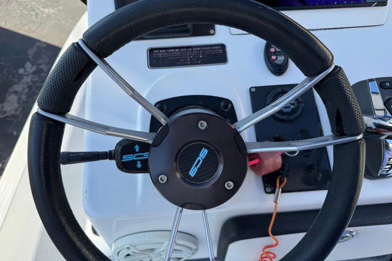 Slide: The Image of Steering wheel of a 2018 SCB Recon boat with control panel and throttle. - 12