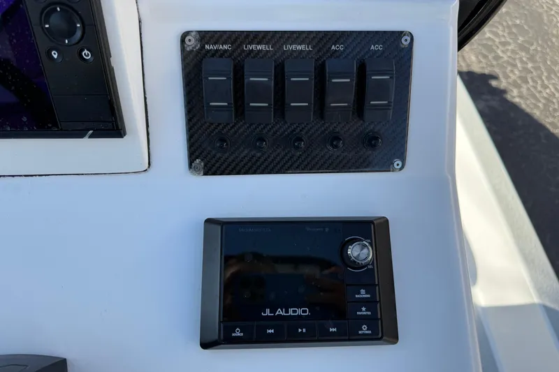 Slide: The Image of Control panel of a 2018 SCB Recon boat with JL Audio system and switches. - 15