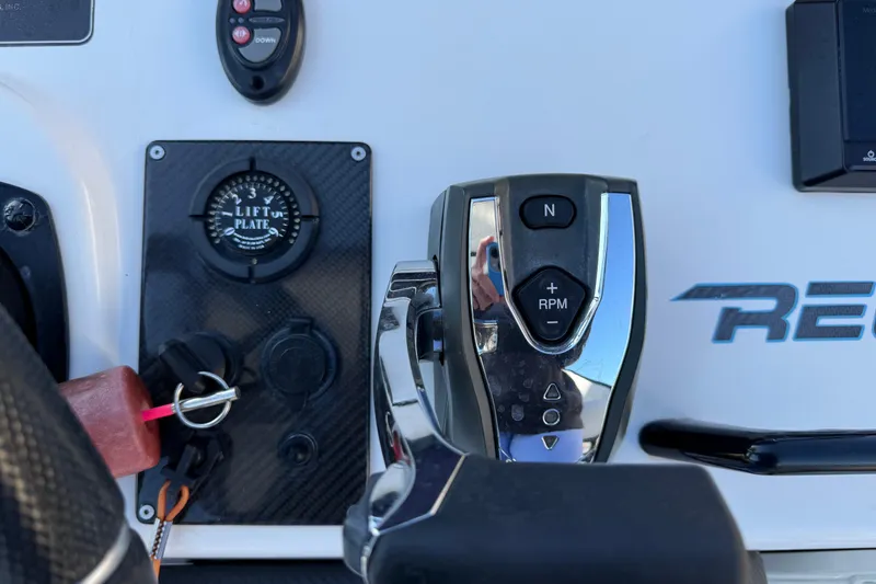 Slide: The Image of Control panel of a 2018 SCB Recon boat with lift plate and throttle. - 16
