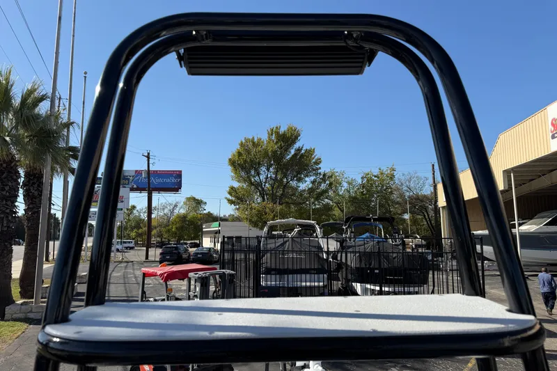 Slide: The Image of 2018 SCB Recon boat with T-top frame in outdoor dealership setting. - 18