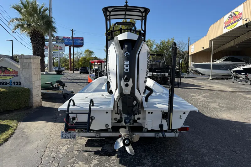 Slide: The Image of 2018 SCB Recon boat with Evinrude 300 engine, parked outside dealership. - 2