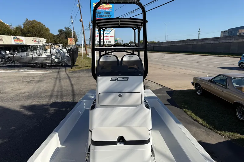 Slide: The Image of 2018 SCB Recon boat displayed outdoors near a highway and dealership. - 23